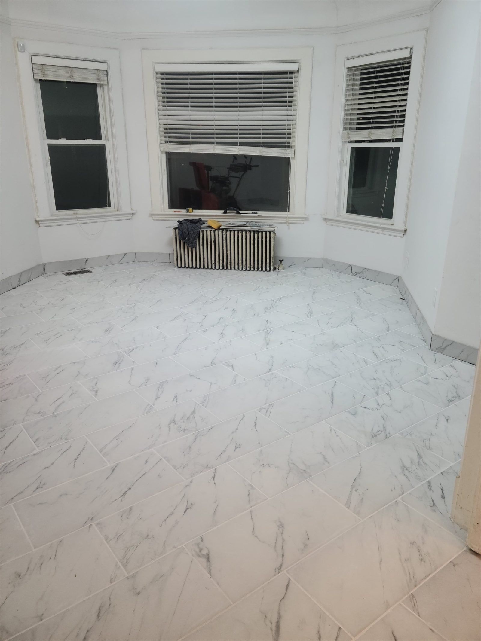 Marble-look floor tile fitted around a bay window