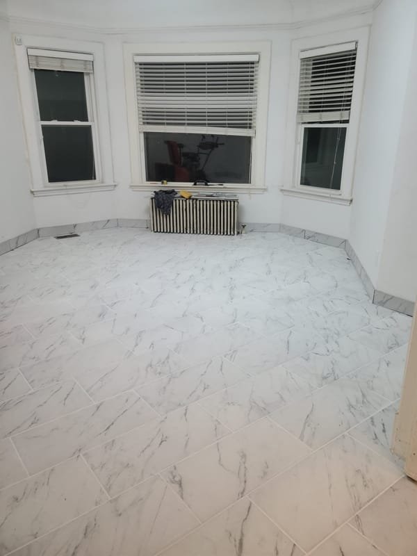 Marble-look tile floor in a bay-window room