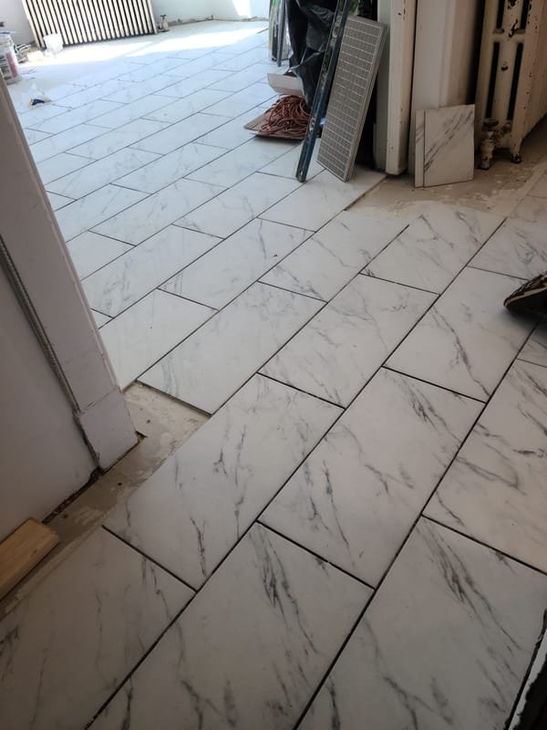 Marble-look porcelain floor laid on the diagonal