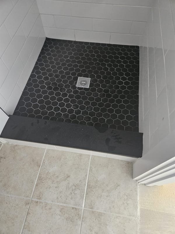 Black hexagon mosaic shower floor