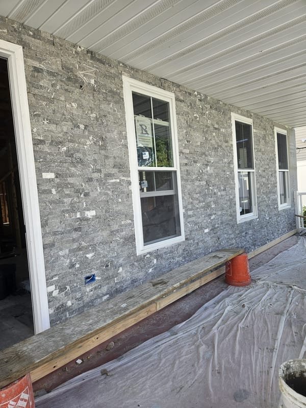 Gray stacked-stone veneer facing on a porch
